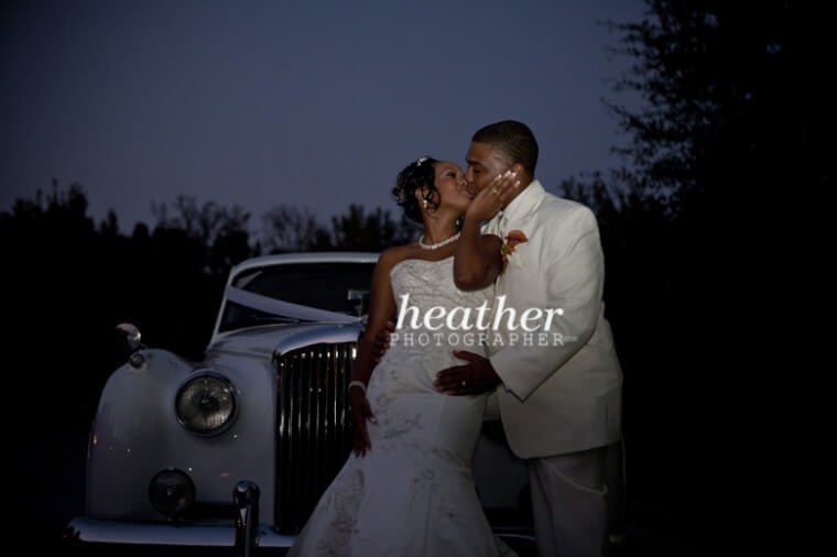 Sharing a kiss in front of the Bentley.