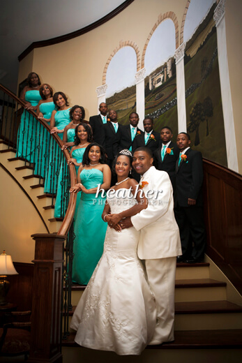 The wedding party gathered for a photo on the manor's staircase.