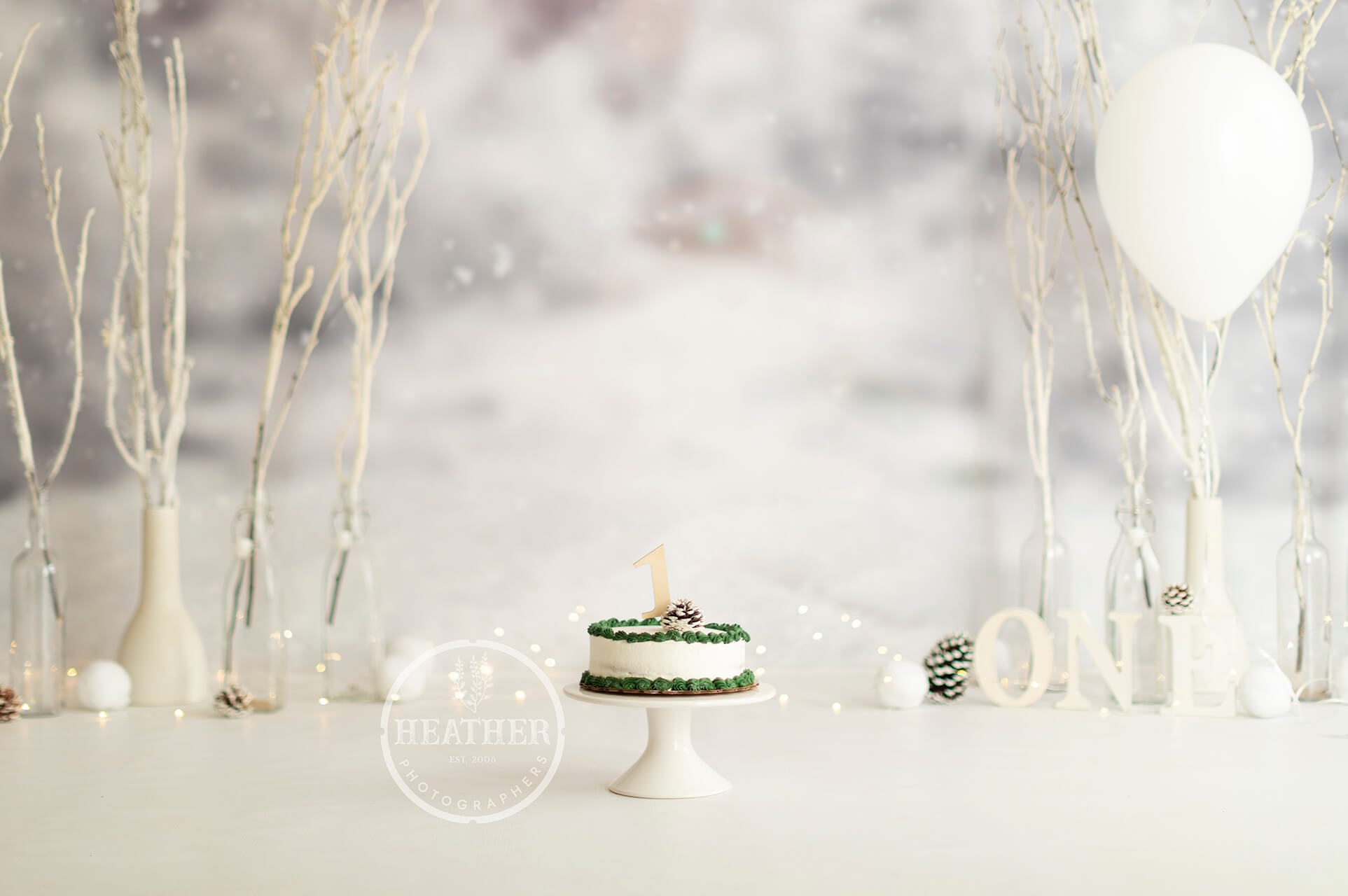 A festive backdrop featuring snowflakes, snowmen, and the number one, perfect for celebrating a first birthday with a winter theme.